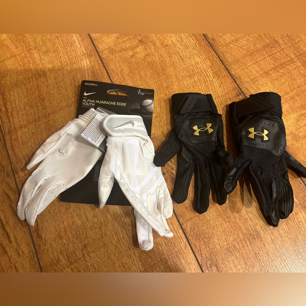 2 sets of Batting gloves. White is Y Sm. Black is Y Med.